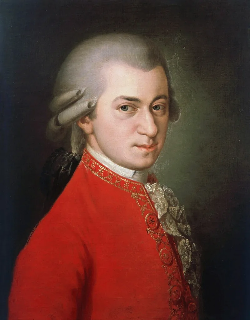 A posthumous portrait of Wolfgang Amadeus Mozart in a red coat, holding a sheet of music